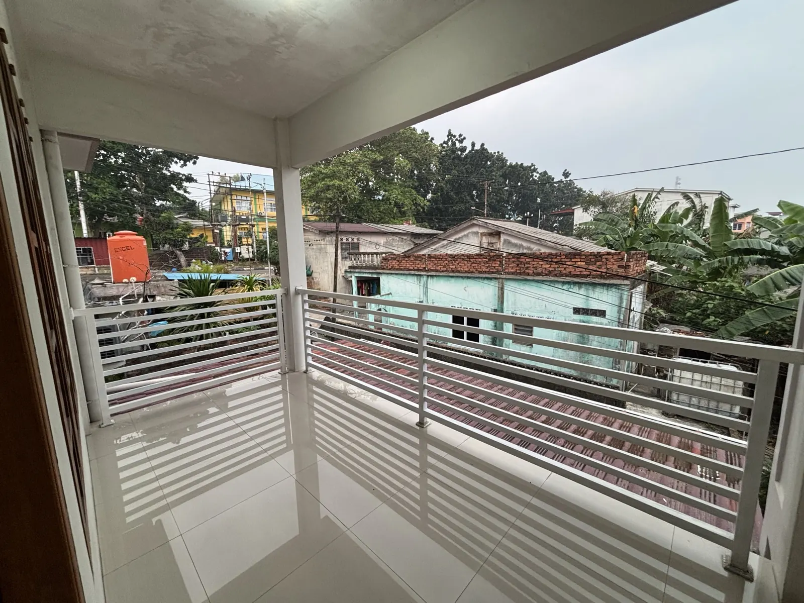 Shared balcony with a railing on the upper floor