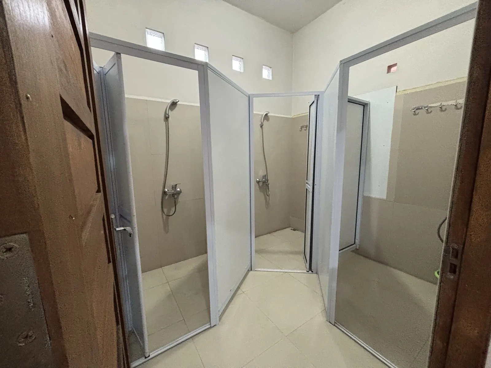 Shared bathroom with enclosed shower cubicles